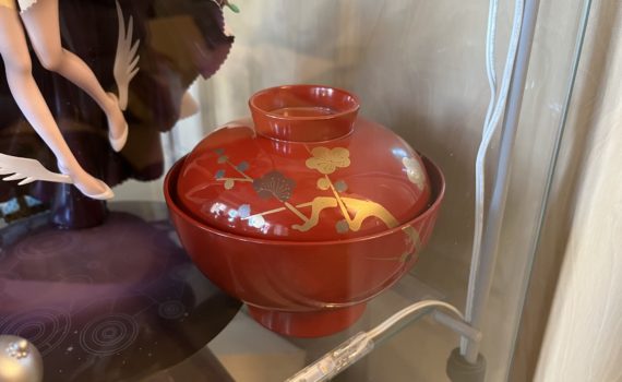Photo of a red lacquerware bowl with a plum blossom design.