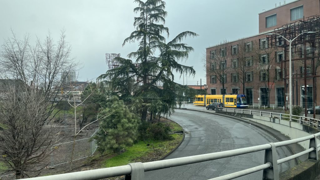 Photo of Portland Streetcar 023 at SE Grand & Hawthorne as seen from a TriMet line 6 bus.