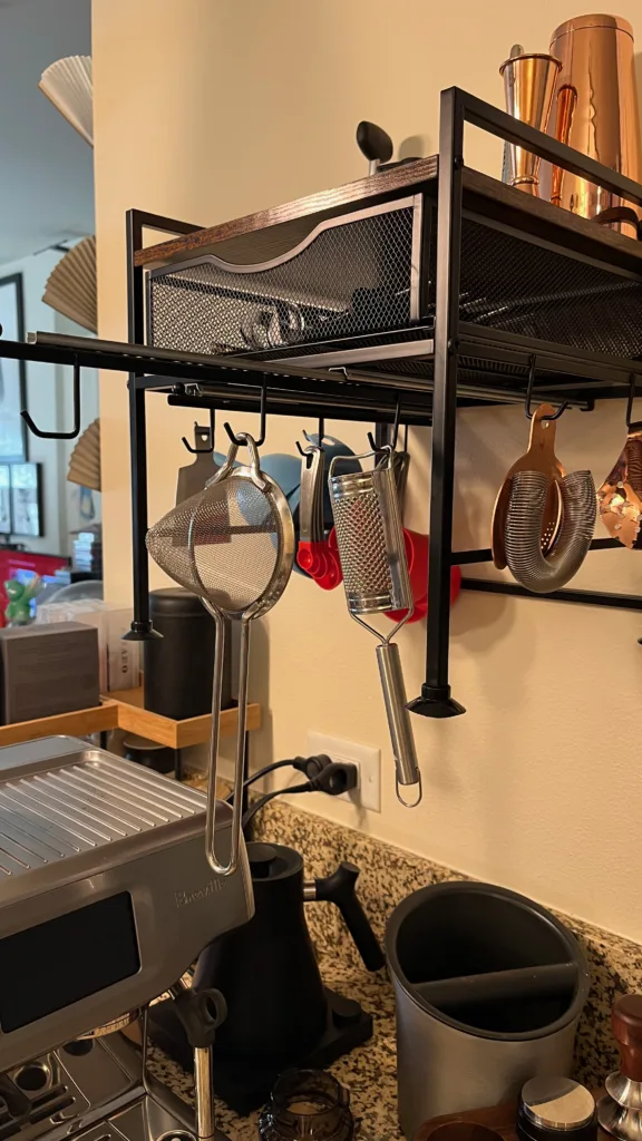 Photo detailing a pull-out set of hooks on a kitchen organizer mounted to a wall.