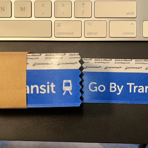 Photo of "Go By Transit" badge ribbons.
